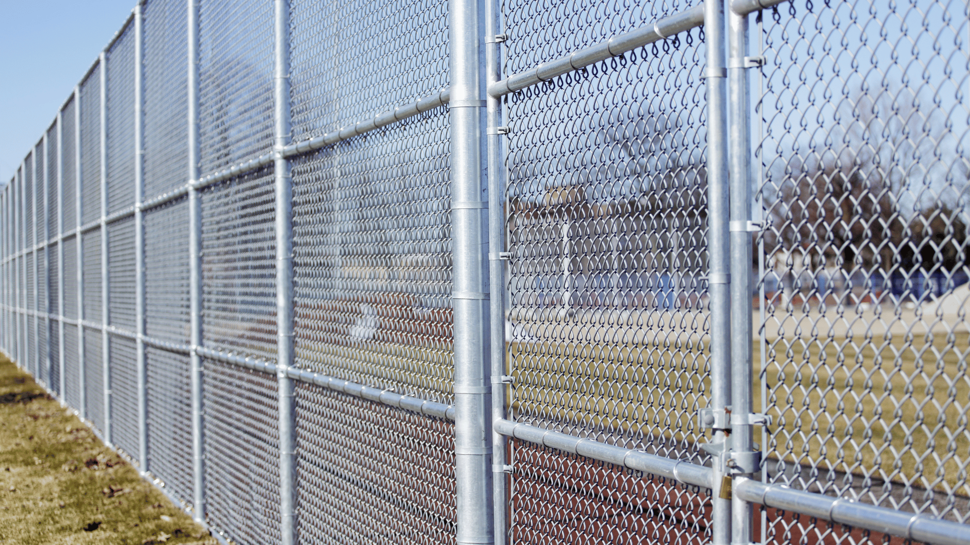 Galvanized chain link fence enclosing a sports field